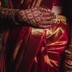 The rich maroon stain of the henna complements the bride's traditional red silk saree perfectly. This is the beautiful result of my all-natural henna paste.