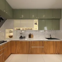 This kitchen interior features a beautiful combination of olive green and teak wood finish laminates. We designed it with moving shutters to conceal appliances, lacquered glass for a touch of luxury, and ample storage to create a space that is both organized and elegant.