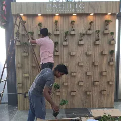Here is our team meticulously setting up the Ginseng Ficus bonsai wall. Each plant is carefully placed by hand to achieve the final, stunning design. We manage the entire installation from start to finish.