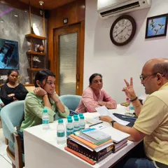 Here I am in a personal consultation session, explaining the details of a numerology report. I believe in a hands-on approach, analyzing every detail myself rather than using software. This allows me to connect with my client's story and provide truly personalized and heartfelt guidance for their life, career, and relationships.