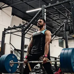 A close-up of a heavy sumo deadlift in progress. This lift requires immense grit and focus, embodying the mindset I work to instill in my athletes.
