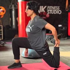 A member holding a quad stretch. This is an essential part of our cool-down routine to help with muscle recovery and improve flexibility.