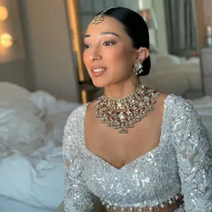 A clean, modern, and sophisticated bridal look. I created this sleek, center parted low bun to provide a perfect base for the maang tikka and to highlight the bride's features and stunning jewelry.