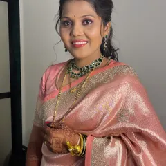 A full view of the reception look. The soft pink saree and emeralds are a classic combination for post-wedding events.