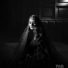 In the quiet moments before the vows, a bride's beauty shines brightest. We use dramatic lighting and monochrome tones to create timeless, artistic bridal portraits that feel both powerful and serene, capturing the soul of the moment.