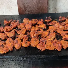 Boneless fish fillets marinated in a red masala, being fried on a tawa. These are crispy on the outside and soft on the inside.