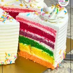 A slice of pure joy. Our Rainbow Cake features vibrant, soft layers of sponge with delicate cream cheese frosting in between, showing the fun and precision we put into our celebration cakes. It's a favorite for birthdays and happy occasions.