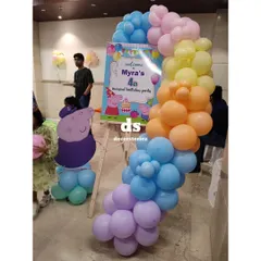 A personalized welcome easel for a Peppa Pig party. This custom sign, framed by a pastel balloon garland, is a great way to greet guests and set the theme from the moment they arrive.