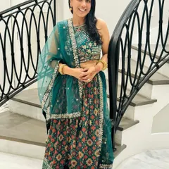 This client is ready for a celebration in a gorgeous teal lehenga with intricate patterns. She has accessorized it beautifully with simple gold bangles and earrings, letting the outfit shine.