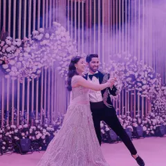 The couple's first dance at their reception, surrounded by smoke effects and beautiful decor. A truly magical and cinematic moment.
