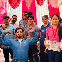 Posing with my team and fellow competitors after a successful competition. Celebrating the win with a bicep flex.