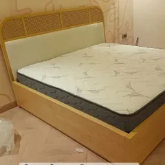 I love adding natural textures like cane to my designs. This bed features a headboard with woven cane panels and a light wood frame, perfect for a breezy, contemporary bedroom.