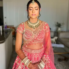 A serene moment showing the complete bridal look. The floral bun adds a fresh and natural element to her traditional attire.