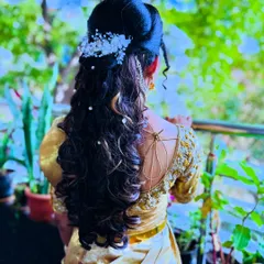 A beautiful reception hairstyle for my bride Chitra. This look combines soft curls and a half-updo with delicate floral accessories, perfect for a modern yet elegant bridal style.