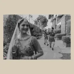The moment the groom's procession arrives is full of anticipation. I used a creative focus technique here to capture the bride, Yashika, in the foreground, with the approaching baraat creating a sense of story and excitement.