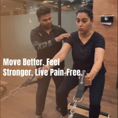 I believe in a hands-on approach. Here, I'm providing a client with specific tactile cues to ensure correct shoulder and back alignment, which is crucial for safe and effective movement.