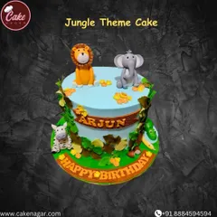 A charming jungle theme cake with fondant animals like a lion, elephant, and zebra. The cake is decorated with edible leaves and vines to create a fun, wild atmosphere for a birthday.