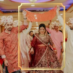A beautiful bride making her entrance. This heavily embroidered maroon velvet lehenga is a testament to traditional bridal elegance, a classic choice for the main ceremony.