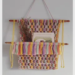 Looking for decor that is also functional? This elegant macrame wall pocket is a perfect choice. The multi-colored design adds a pop of color to any wall, and you can use it to hold a book, mail, or some pretty dried flowers.