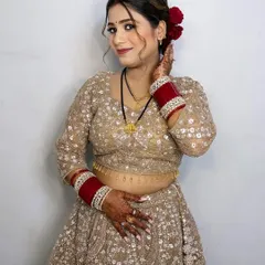 A happy and confident look for the wedding festivities. The hair is styled in a beautiful updo with loose curls framing the face.