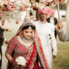 A closer look at the bride's serene expression during her entrance. The soft, elegant makeup enhances her features beautifully, creating a timeless and graceful image.
