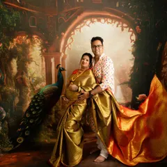 A beautiful couple's portrait in traditional Indian attire. I help style the saree to flow elegantly even in a seated pose with your partner.