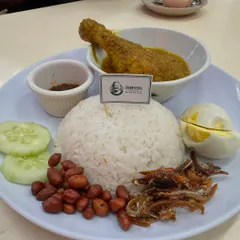 This is Nasi Lemak, what many call the national dish of Malaysia. It’s fragrant rice cooked in coconut milk, served with a spicy sambal, crispy anchovies, peanuts, cucumber, a hard boiled egg, and a delicious chicken curry. It’s a complete meal and a true taste of home.