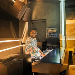 A candid shot of me at the DJ booth, ready for the night ahead. I love the atmosphere of a club just before the party starts.