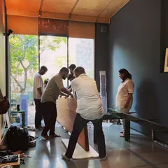 Teamwork is essential as we maneuver the heavy oak table into its final position. This process reflects our collaborative and hands-on approach to every aspect of design.