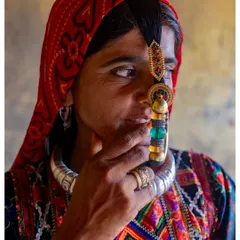 A close-up portrait of a Dhaneta Jat woman from Kutch, Gujarat. The focus is on her traditional, large nose ring, a symbol of her marital status and cultural identity.