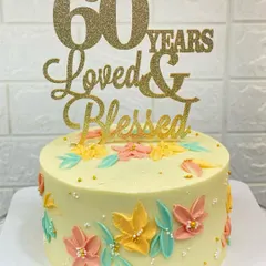 A beautiful cake for a 60th birthday, featuring delicate, hand-painted flowers made with a palette knife technique. The message "60 Years Loved & Blessed" says it all.
