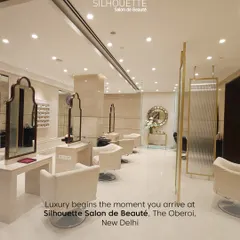 Luxury begins the moment you arrive. This wide view of our salon showcases the bright, clean, and spacious environment we have created, with elegant styling stations and thoughtful lighting for a premium experience.
