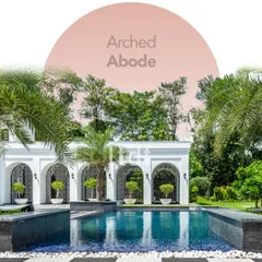 Titled 'Arched Abode,' this design fuses modern architecture with classical elements. The pristine white arches frame the tranquil pool area, creating a space thoughtfully designed for relaxation and well-being.