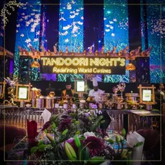 Our branding is a promise of quality. This image captures one of our signature food stations at a glamorous event, showcasing our professional setup and commitment to creating a luxurious ambiance.