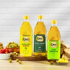 A refined composition of Oleev Kitchen's olive oil trio. We styled this shot with fresh Mediterranean ingredients like tomatoes, olives, and bread to highlight each variant's culinary use in a bright, clean kitchen setting.