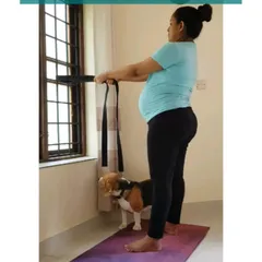 Using a yoga strap looped around a stable object is a great way to practice dynamic Malasana, allowing you to move in and out of the squat with support.
