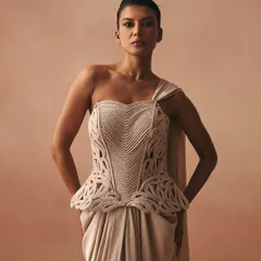The Karov ensemble, featuring a sculpted corset with paisley-inspired zari cord work. The peplum detail softens the structure, creating a modern Indo-Western look when paired with a satin drape skirt.