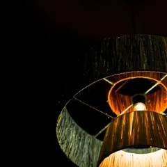 An angled view from below the lit fiber lamp, showing how the light is diffused through each tier. This design creates a soft, cascading glow.