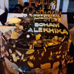 A rich chocolate almond cake made for a special 10th birthday. This cake is covered in chocolate ganache and loaded with toasted almonds for a wonderful crunch.