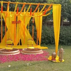 A classic and simple Haldi decor setup for an outdoor lawn. I used bright yellow drapes, marigold garlands, and elegant seating to create a traditional and auspicious space for the ceremony.