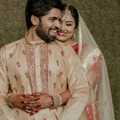 A candid, happy portrait of a couple during their Bengali wedding ceremony, their smiles radiating pure joy.