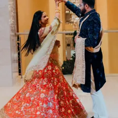 A beautiful action shot of a couple during their sangeet performance, with the bride's lehenga in full twirl, capturing the joy of the celebration.