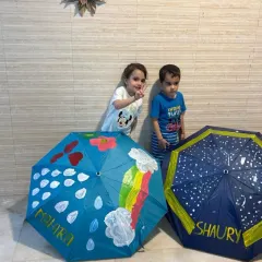 Two of our youngest artists posing with their hand-painted umbrellas. It’s amazing to see what they can create when given the freedom to explore.