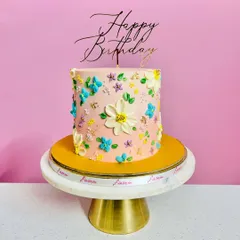 Hand-painting on buttercream is becoming my new favorite thing. This cake features a garden of delicate, hand-painted flowers, giving it a beautiful, artistic, and textured finish.