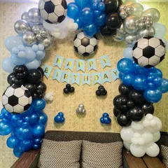 Goal. A fun soccer-themed party setup perfect for sports fans. We used blue, black, and silver balloons to create an arch and incorporated multiple soccer ball foil balloons throughout the design.