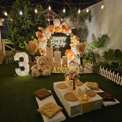 My bohemian picnic setups are perfect for a relaxed and stylish celebration. This birthday party features low seating with comfortable cushions, a beautiful balloon arch in earthy tones, and a personalized neon sign, all arranged for a cozy gathering.