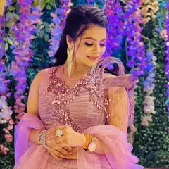 A stunning party look in a unique lavender lehenga. The makeup is soft yet glamorous, with defined eyes and a subtle glow, perfect for an evening event.