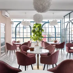 The completed Zoca café, realizing the vision from our illustration. The elegant arches, pink chairs, and airy ambiance are a direct translation of the initial concept.