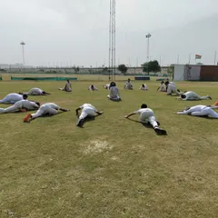Cool-downs and flexibility are just as important as the main workout. Here, players are performing essential stretches to aid muscle recovery and improve their range of motion for better performance.