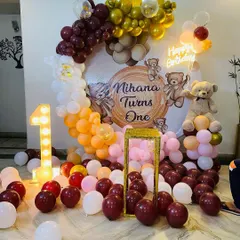 Here is a teddy bear themed first birthday party setup. I used a warm color palette of maroon, orange, and gold balloons, a custom printed backdrop, a large teddy bear prop, and a light-up number one to complete the look.